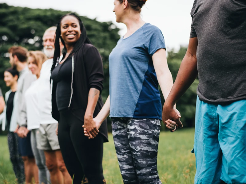 Row of people holding hands for a non-profit, charity fundraiser